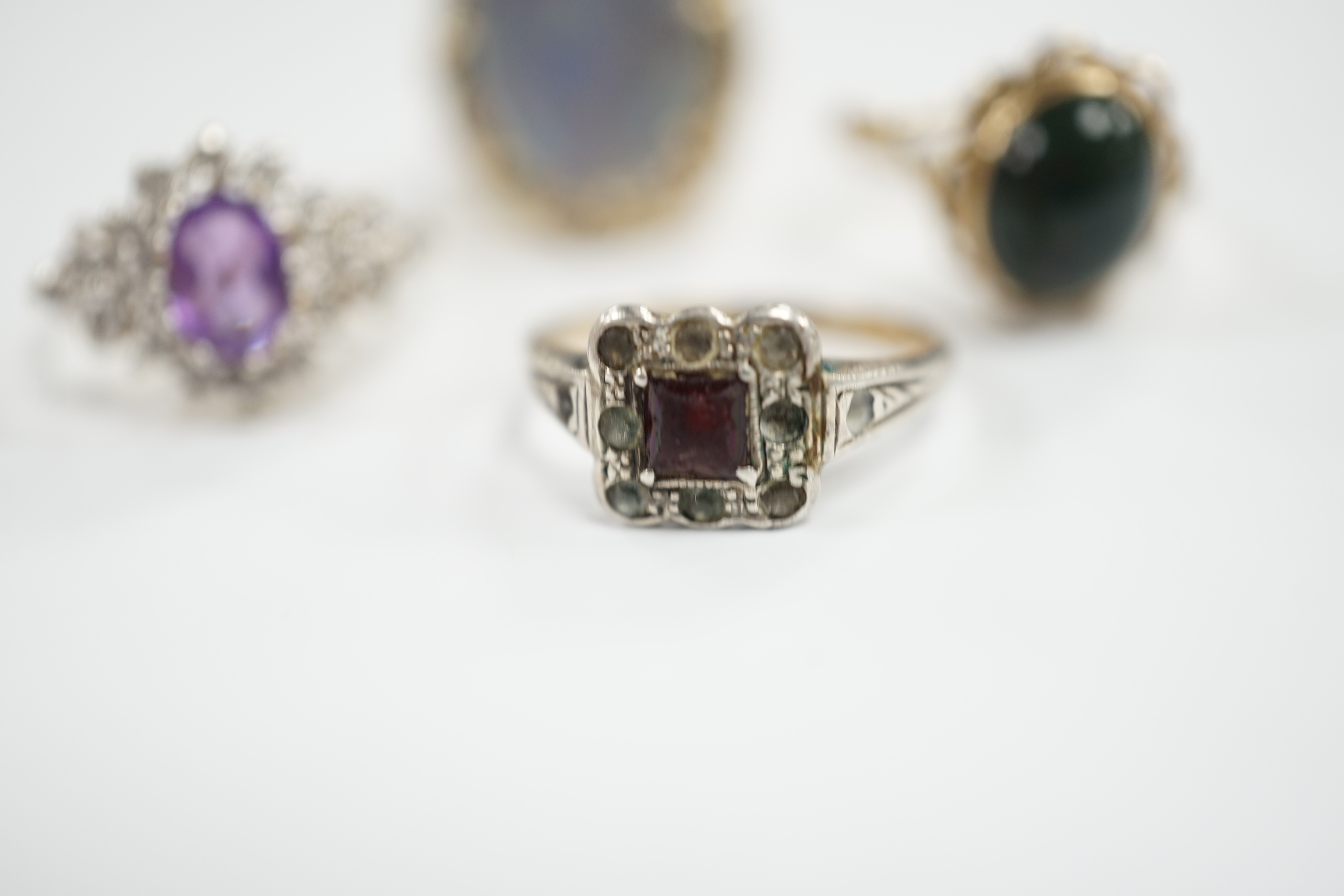 Two 9ct and gem set rings including cabochon bloodstone, a 14k and opal? doublet set ring and one other ring.